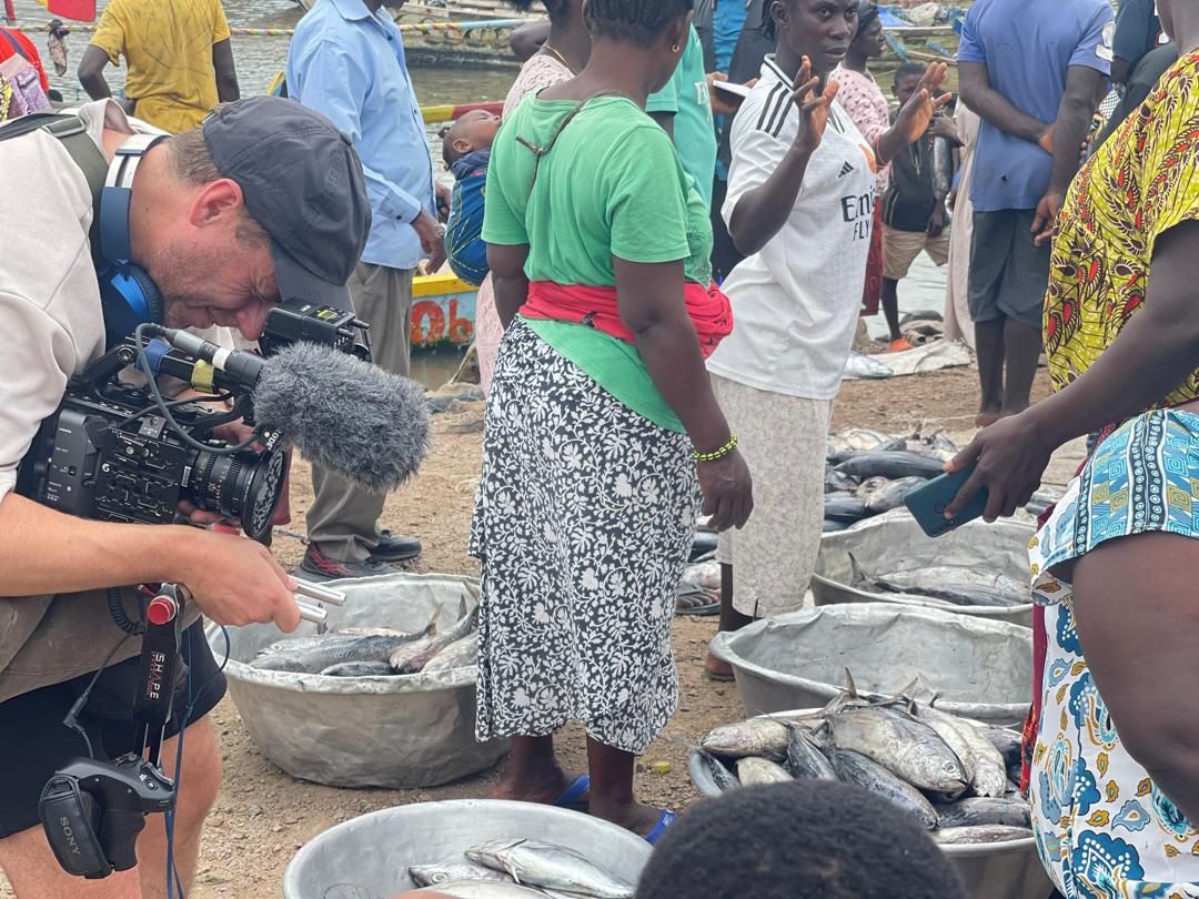 Crew filming fishmongers at work in the Dixcove fish market
